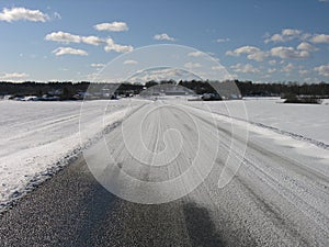 A country road where snow has drifted across in rural Blekinge