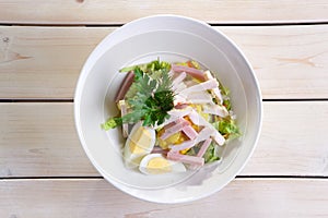 Country salad with egg, ham, chicken fillet and vegetables