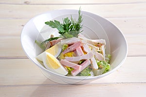 Country salad with egg, ham, chicken fillet and vegetables