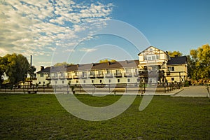 Country side rancho and hotel rural building apartment landscaping with with green grass meadow foreground photo