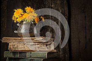 Country still life with bouquet and old things, books