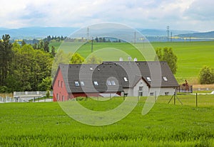 Country style house with green field