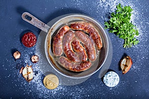 Country style oven-baked sausages in a frying pan