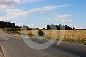 Country summer landscape with a road. Hitch-hiking on the roadside