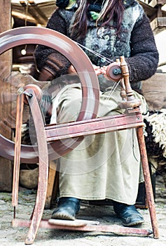 Country woman on spinning wheel
