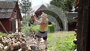 Countryman work with axe woodshed near living village home. 4K