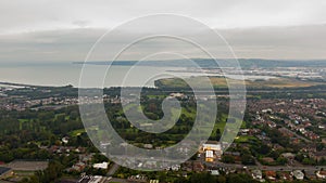 Countryside, aerial view on houses near coast of Irish sea in Belfast Northern Ireland. Cloudy sky above seaside