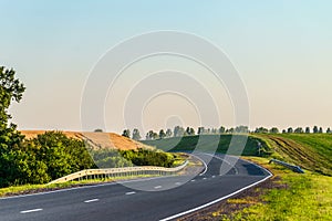 Countryside asphalt road with marking and guard rails