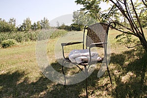 Countryside Chair with Blanket. Still Rural Country Style in the Garden, Trees, Field of Wild Flowers, Summer. Outdoor, Canada.