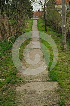 Countryside concrete pathway going up the hill