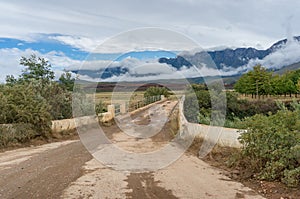 Countryside dirt road landscape. Rural travel with unsealed road and bridge