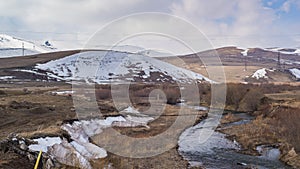 Countryside Hills and Stream Covered In Snow In Armenia