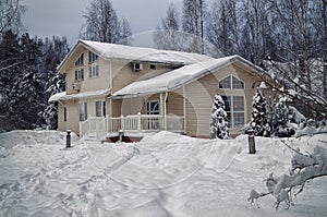 Countryside house heavily covered with snow in january