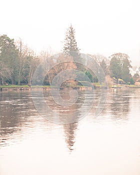 A Countryside Landscape with Tree and Reflection in Water