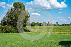 Countryside landscape view over the agriculture fields with the church tower in the background around Rijswijk, The Netherlands