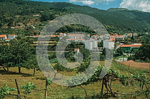 Countryside landscape with white houses next to hill