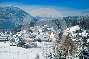 Countryside landscape in winter in Croatia, panoramic view of town of Lokve under snow in Gorski kotar