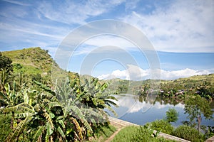 Countryside on a large tropical island. Small village on the green hills by the river. The nature of the Philippines