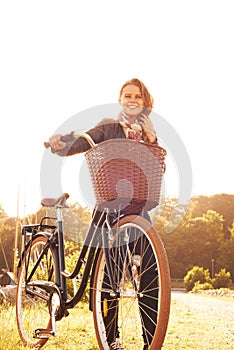 Countryside, nature and portrait of happy woman with bicycle, adventure or travel in morning. Summer, smile and bike