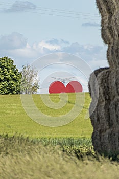 Countryside passion concept, big red heart in the middle of the fields