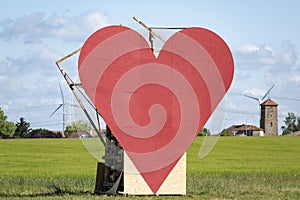 Countryside passion concept, big red heart in the middle of the fields