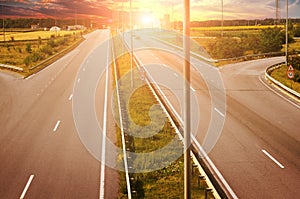 The countryside road with cars and forest with fields against sk