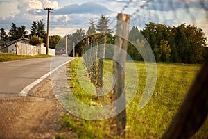 Countryside road with fence and barbed wire