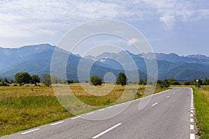 A countryside road leading to a mountain village