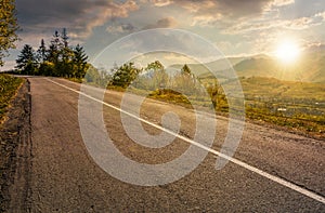 Countryside road through mountains at sunset