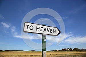 In the countryside a road sign with the inscription heaven.