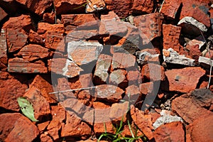 Countryside road surface made of broken red bricks.