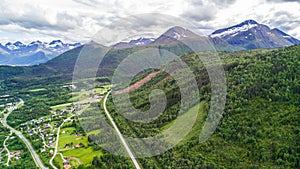 Countryside road to the sea in summer in Alnes, godoy island, Norway. Aerial shot from drone of norway landscape