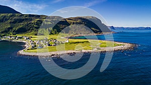 Countryside road to the sea in summer in Alnes, godoy island, Norway. Aerial shot from drone of norway landscape