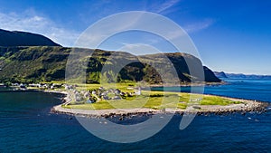 Countryside road to the sea in summer in Alnes, godoy island, Norway. Aerial shot from drone of norway landscape