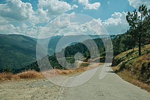 Countryside roadway passing through hilly landscape