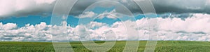 Countryside Rural Green Wheat Field Meadow Landscape In Summer Sunny Day. Scenic Sky With Clouds On Horizon. Panorama