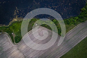 Countryside view with a beautiful lake at sunset. Aerial view. From above