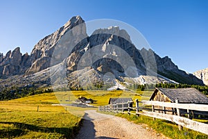 Countryside view of Dolomites mountains. Houses in mountains against Munt de Fornella, South Tyrol, Italy photo
