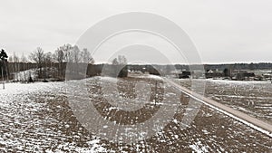 Countryside view with ploved agriculture fields and farm