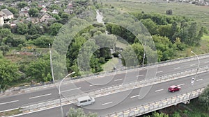 Countryside with village houses and car highway road. Drone shot of beautiful nature with river, trees and village. High speed mot