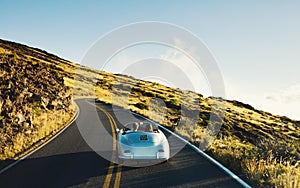 Coupe Driving on Country Road in Vintage Sports Car