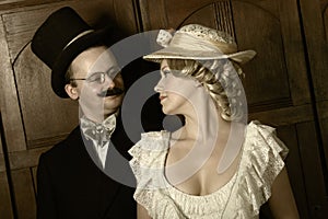 Couple in 19th century garment with woman in dominant role