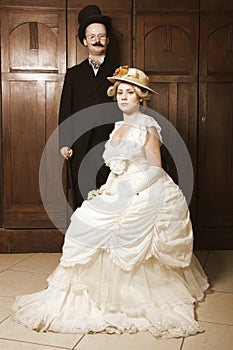 Couple in 19th century garment with woman in dominant role