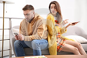 Couple addicted to smartphones ignoring each other. Relationship problems