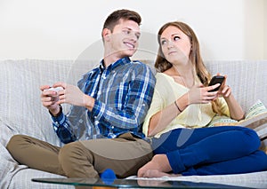 couple addicted to social networking with cell phones