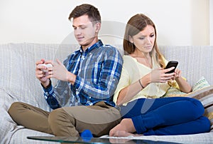 couple addicted to social networking with cell phones