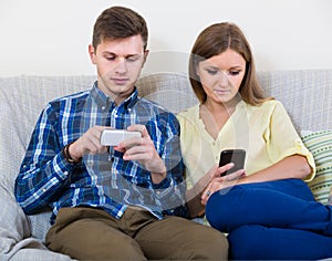 Couple addicted to social networking with cell phones