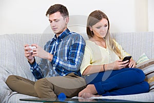 Couple addicted to social networking with cell phones