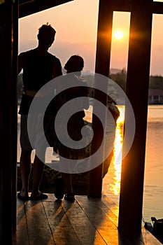 Couple admiring the sunset in Kanchanaburi, Thailand