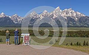Couple admiring the view of the Tetons range WY